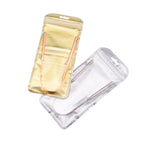 Two pairs of metallic tweezers in clear and gold cases on a white background.