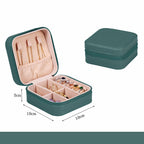 Green jewelry box with jewelry items and dimensions on a white background