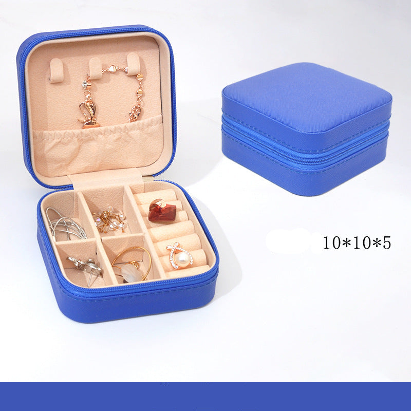 Blue jewelry box with jewelry inside on a white background