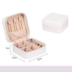 White jewelry box with compartments containing jewelry, dimensions indicated.