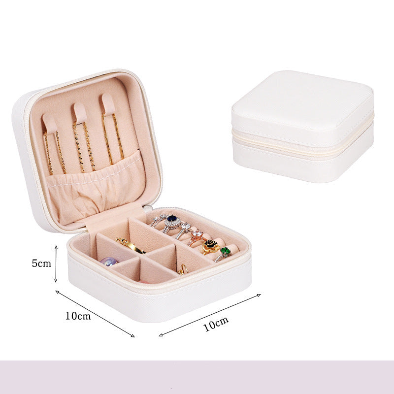 White jewelry box with compartments containing jewelry, dimensions indicated.