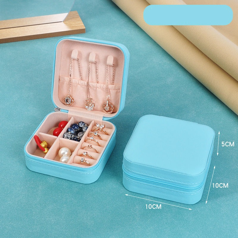 Blue jewelry box with jewelry items on a blue background